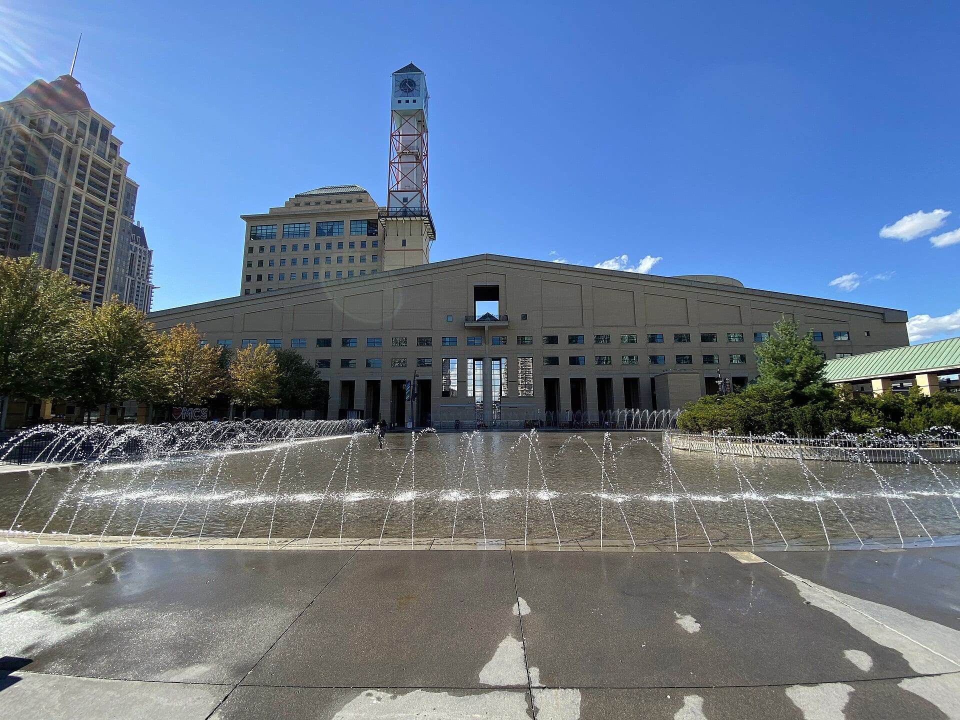 Mississauga City Hall with its clock tower behind the fountains of Celebration Square.
